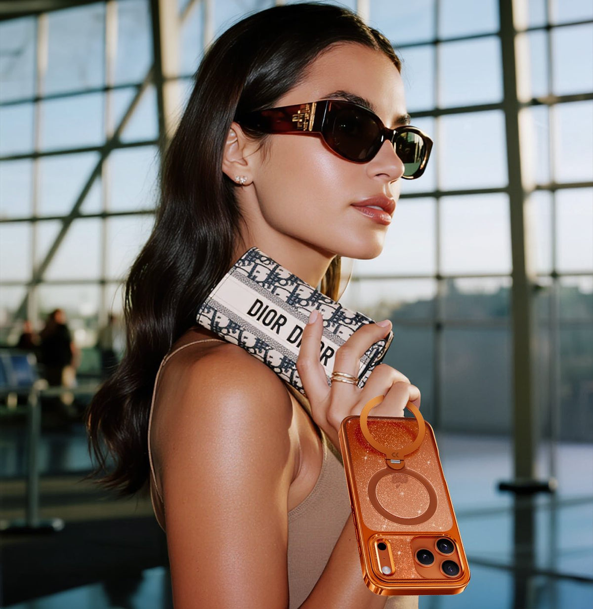 Model carrying StandKOO Glitter Vivid Orange case
