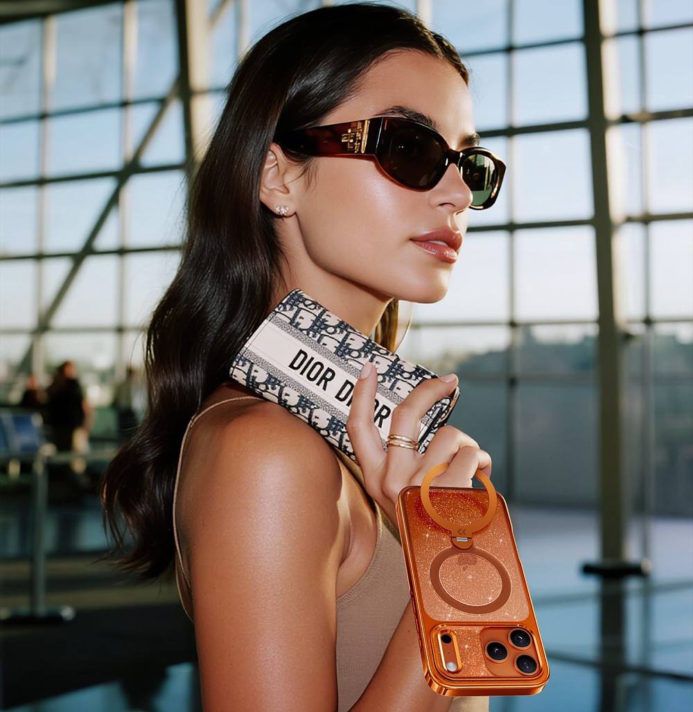 Model carrying a Vivid Orange StandKOO Glitter case at the airport