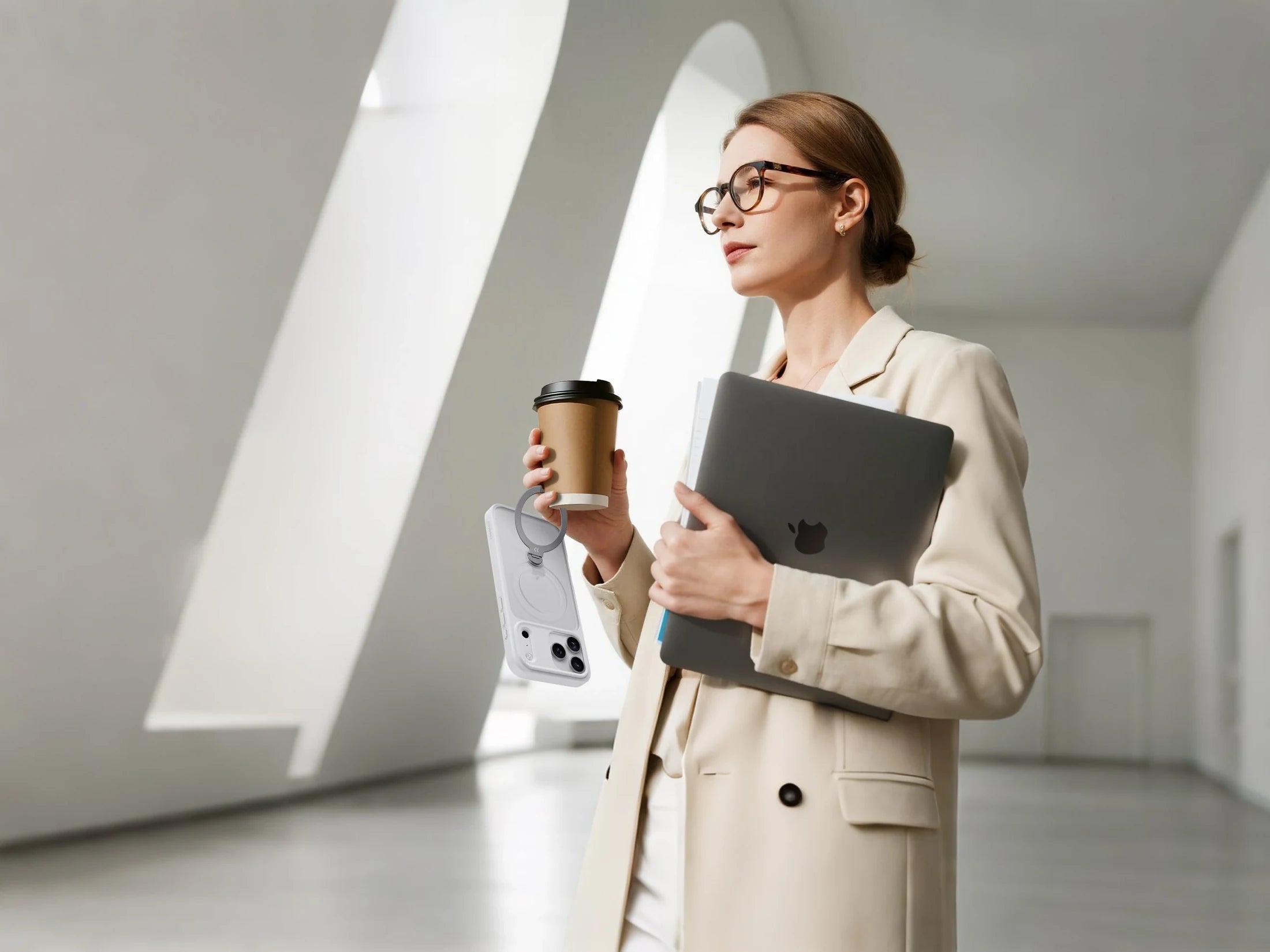 Professional woman carrying a laptop with a StandKOO Frost iPhone case